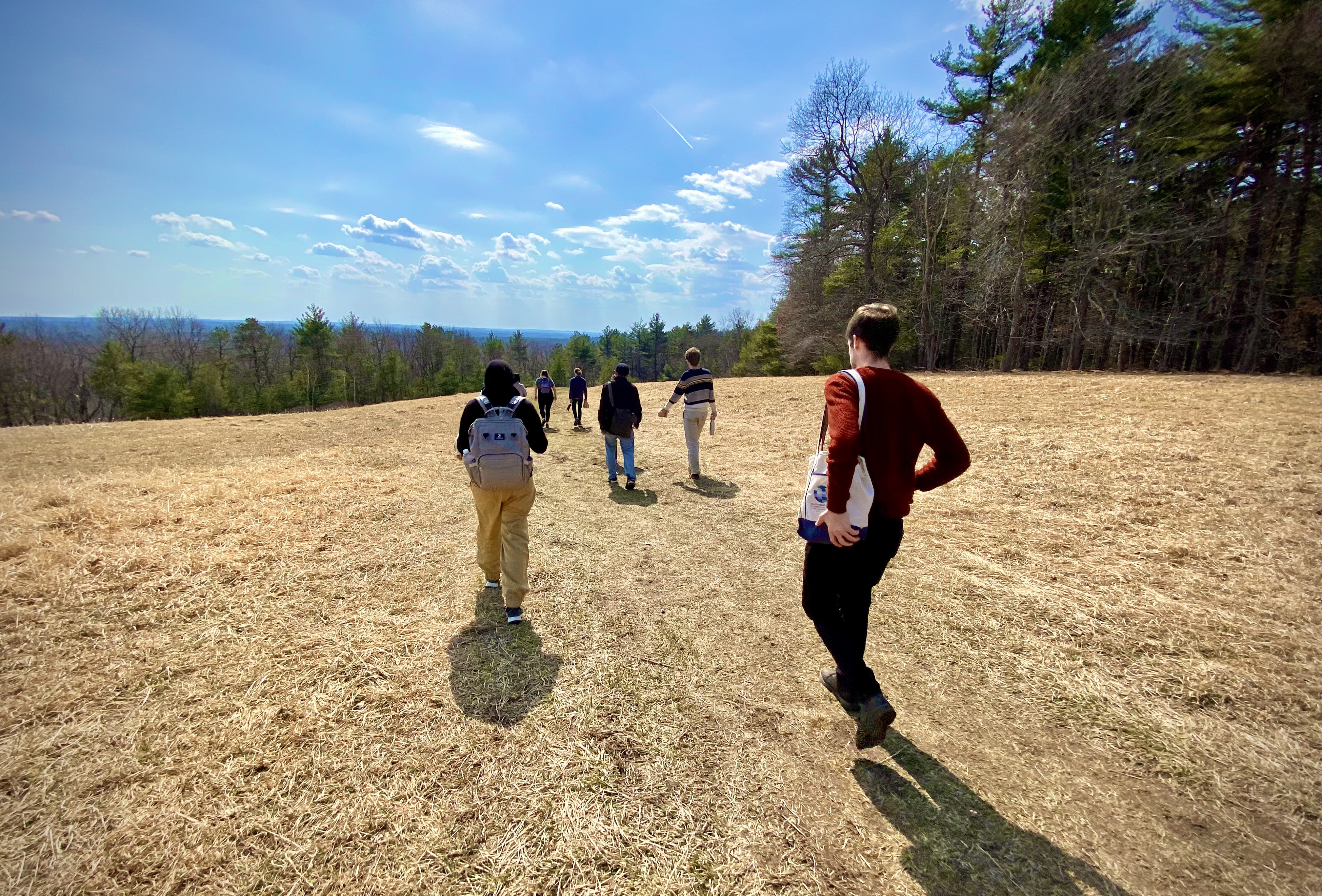 History of Science graduate students hiking into an open pasture
