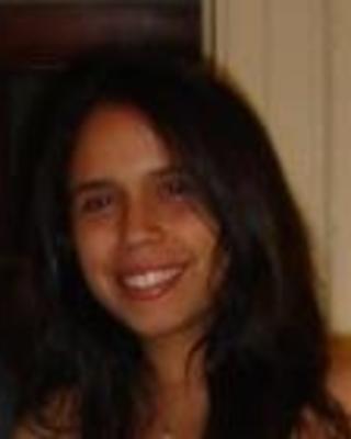 Becerra headshot, smiling, indoor background, head tilted right