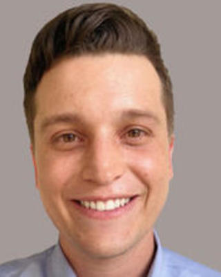 Brinkmann smiling indoors headshot blue shirt visible