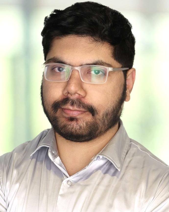 Sri Sathvik Rayala photo wears glasses serious expression lit background